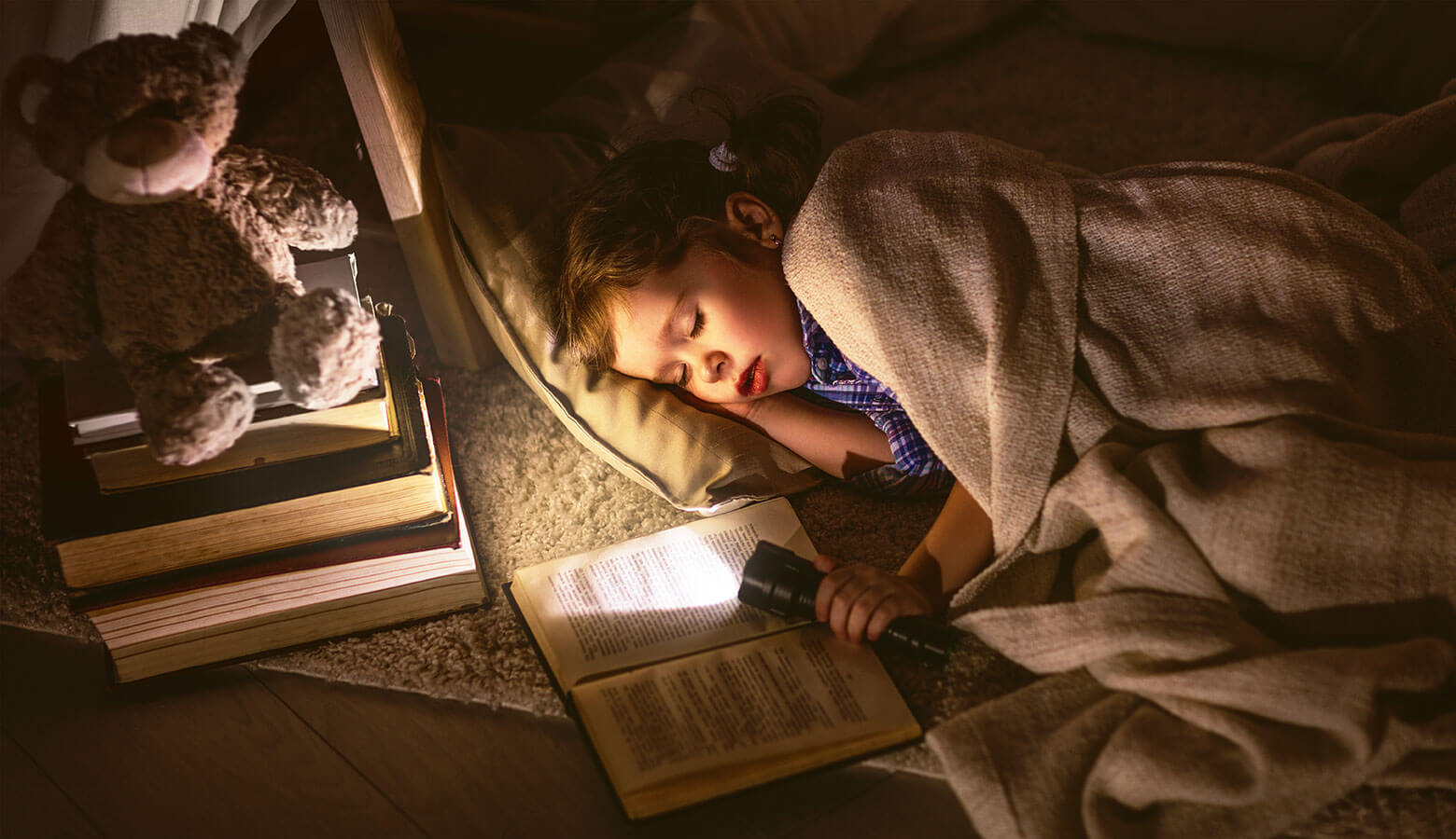 Jeune garçon dormant en tenant lampe de poche et livre dans une maison munie d'une génératrice de secours au propane.